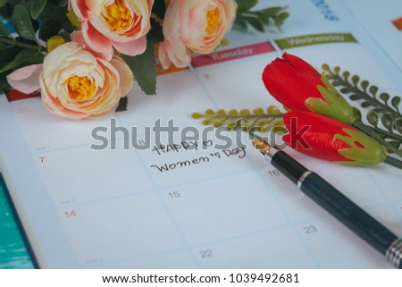 Happy women's day note on calendar book.