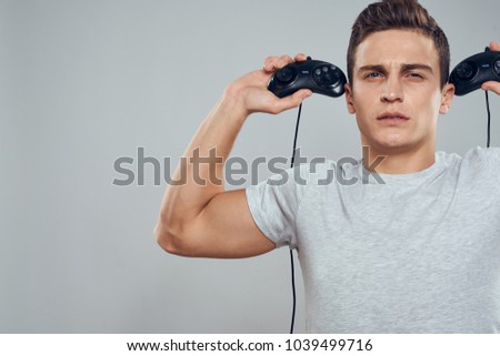man with joysticks on a gray background                    