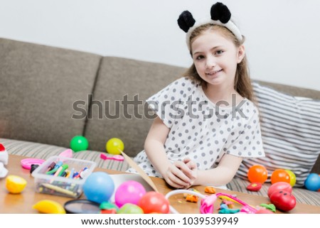 happiness girl kid smile with colorful ball toy on sofa
