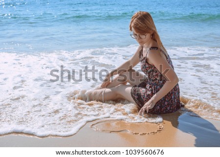 loneliness lonely girl sitting on the beach lonely heart drawing on the sand waiting for love