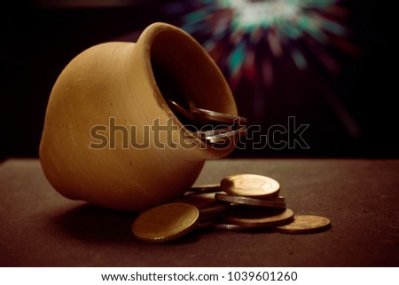 Golden clay pot with piles of coin
