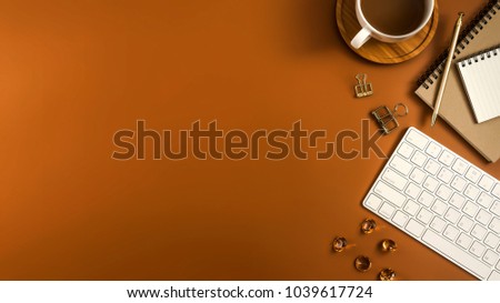 Styled stock photography brown office desk table with blank notebook, computer, supplies and coffee cup. Top view with copy space. Flat lay.