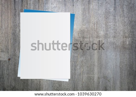 Blank white paper on old wooden background for text input.