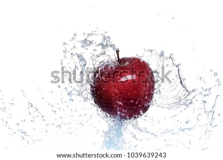 Splash of water on a red apple. On white background.