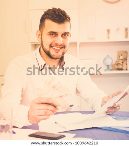 Manager is signing agreement papers of financial nature at home.