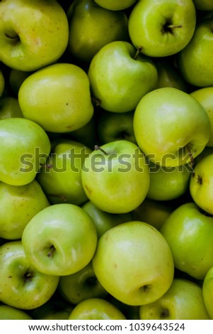 green apples, close-up. large group of green apples in a row. Green Apples Background, shallow depth of field. Background of green apples on sale at the local market.