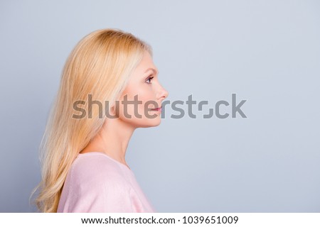 Half-face close up portrait of confident serious focused attractive stunning gorgeous mature lady with long smooth soft healthy hair looking aside isolated on gray background copy-space Royalty-Free Stock Photo #1039651009