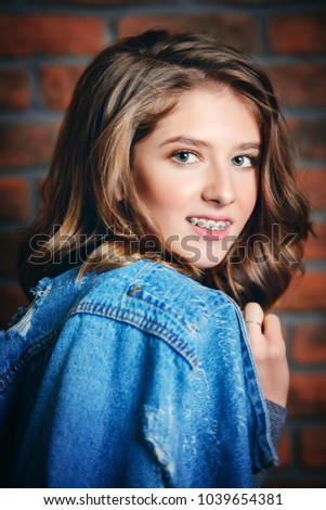 Cute girl teenager wearing dental braces. Healthcare, stomatology and orthodontics.