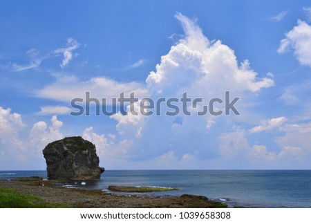 Taiwan, Kenting city seaside, the impact of waves on the lichen Reef rocks, in the blue sky is a beautiful picture and journey.