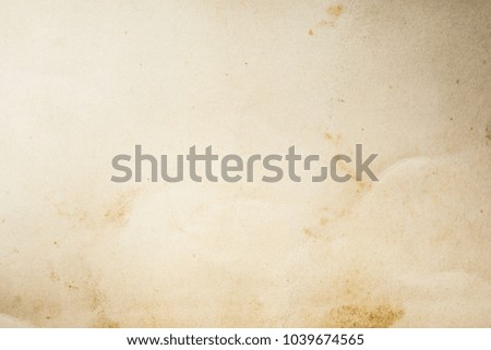 Blank aged paper sheet as old dirty frame background with dust and stains. Front view. Vintage and antique art concept. Detailed closeup studio shot.