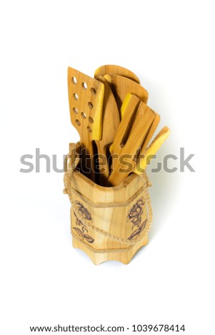 a set of wooden spoons and paddles in a bucket