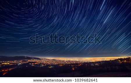 
Night sky star trail over the city