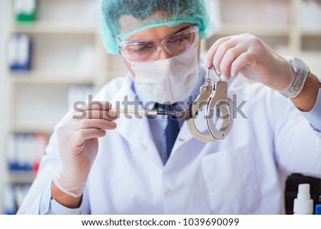 Criminologist police chemist looking at crime evidence