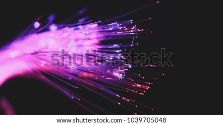 Abstract background fiber optics close up, computer communication technology. Optical lighting. Royalty-Free Stock Photo #1039705048