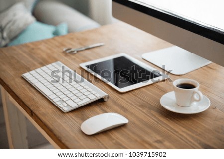 Picture of computer, scissors and camera on working desk