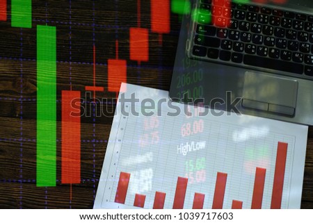 Double exposure of coin stack with stock market screen chart board and candle stick for financial business and investor analysis concept idea.