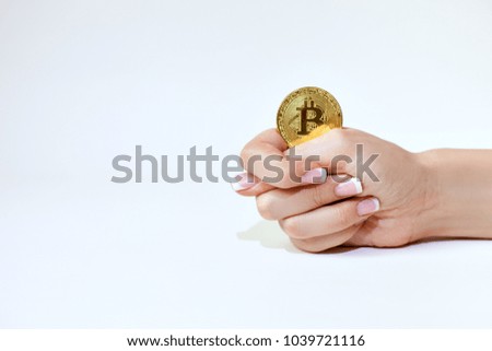 Female hand holds bitcoin and shows fig.
