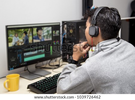 back view of video editor using computer
