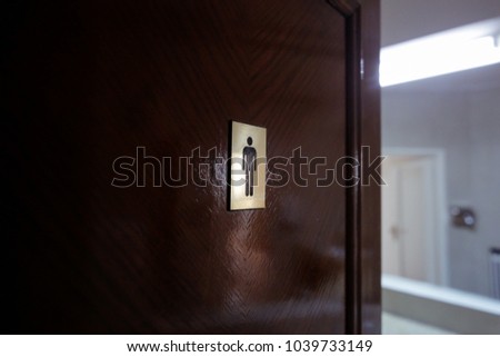 Men toilet sign on a wooden door