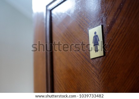 Women toilet sign on a wooden door