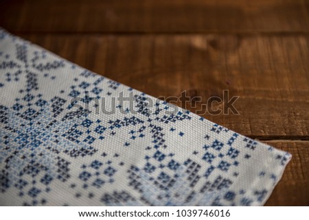 blue and white napkin on a wooden table