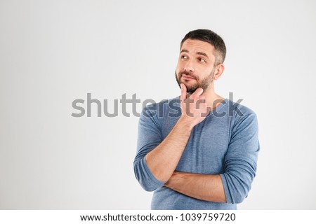 Photo of thoughtful man isolated over white background wall. Looking aside. Royalty-Free Stock Photo #1039759720