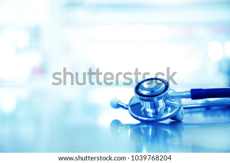 metal stethoscope for doctor diagnosis in blue science laboratory background  Royalty-Free Stock Photo #1039768204