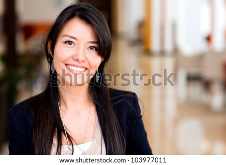 Casual business woman looking happy and smiling