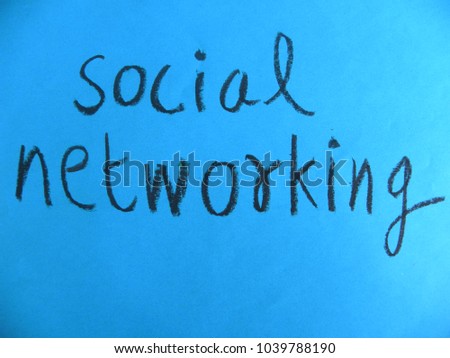 Text social networking hand written by black oil pastel on blue color paper