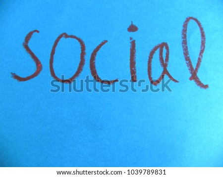 Text social hand written by brown oil pastel on blue color paper