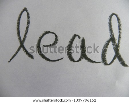 Text lead hand written by black oil pastel on white color paper