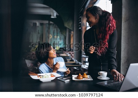 Two african american women with laptop and lunch