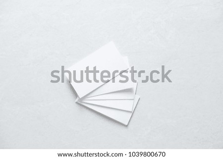 several clean white business cards with space for text on white surface