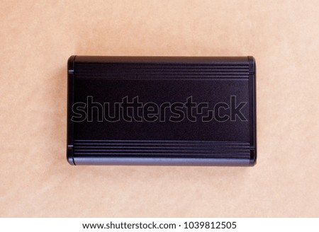 Top view of external computer hard disk drive on beige background