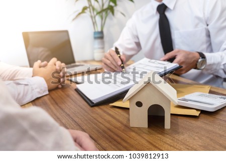 Business Signing a Contract Buy - sell house, insurance agent analyzing about home investment loan Real Estate concept. Royalty-Free Stock Photo #1039812913