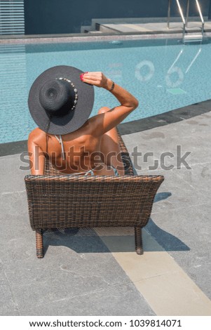 Beautiful woman enjoying summer  at the  pool