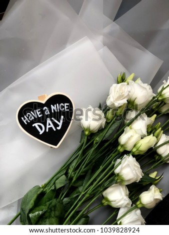 8th March. Mothers day have a nice day chalkboard with flowers on white background. 