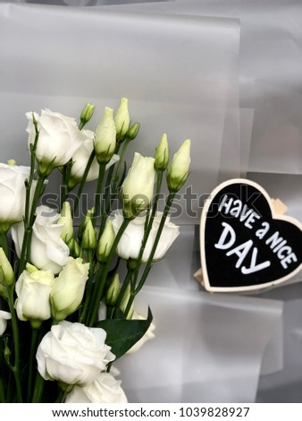 8th March. Mothers day have a nice day chalkboard with flowers on white background. 