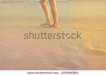 Closeup on female legs by the beach shore outdoors tranquil nature background. Active person walking by coastline, healthy beauty free leisure aspiration lifestyle scene