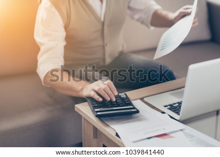 Growth investor auditor graphs bill people think insurance job entrepreneur paperwork plan stock shares person notebook concept. Close up photo of shareholder's hand using pressing buttons calculator