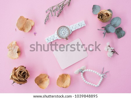 flat lay of women accessories with wristwatch and bracelet on vintage background.