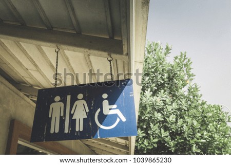 Public restroom signs with disable toilet.
