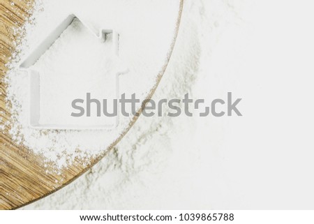 Silhouette of a house on flour for baking as background. Home bakery, home cooking. Copy space for text