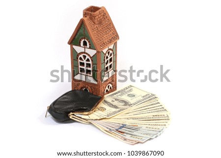 decorative house souvenir and one hundred dollar bills in your wallet