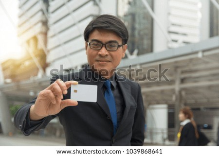 Businessman holding a blank smart card in hand