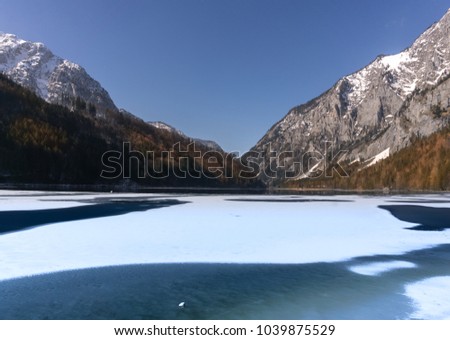 Partly frozen lake in the Alps