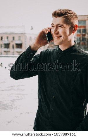 happy man talking on the phone outdoors