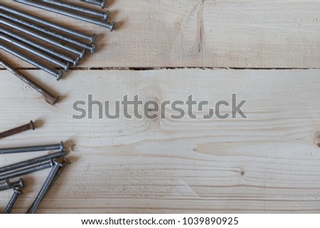 Close-up of nails and hammer on wooden boards