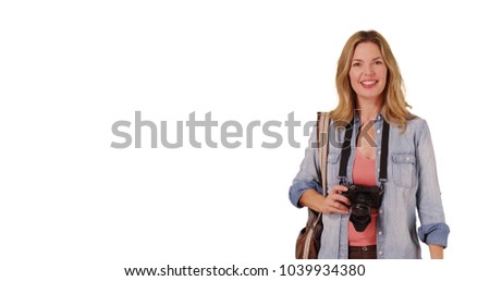 Middle aged Caucasian woman taking photo and talking to camera 