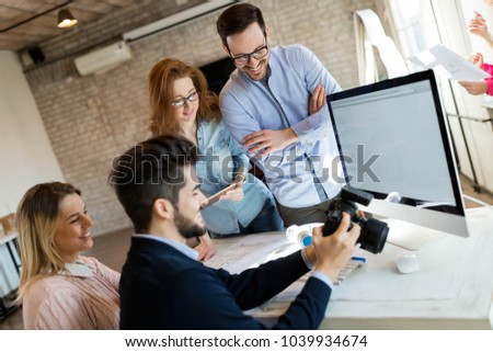 Company photo editor and photographer working together